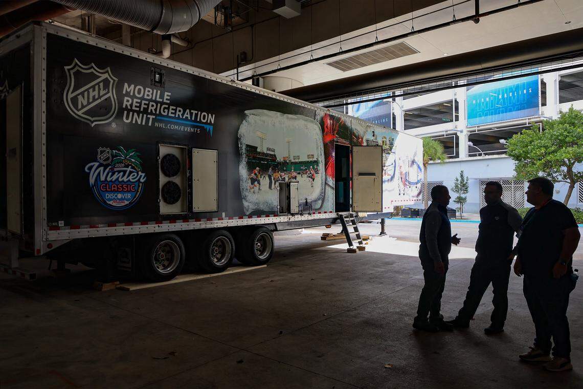  NHL Mobile Refrigeration Units are parked and ready to transform a baseball diamond into a NHL hockey rink as the NHL VP of Hockey Operations, Derek King, left, and Andrew Higgins, NHL’s Senior Manager of Facilities, center, give the media a closer look after the press conference on Wednesday, Dec. 17, 2025, at loanDepot Park in Miami, Florida.