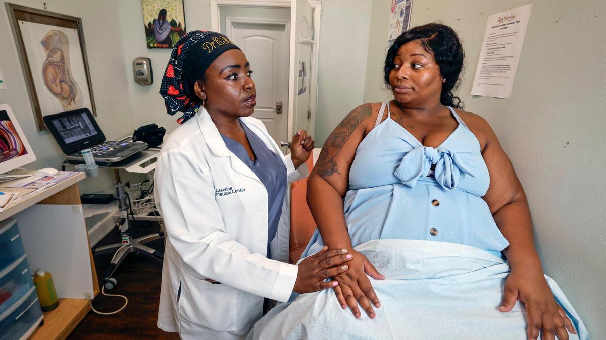 Dr. Christ-Ann Magloire consults with patient Dominique Gray at Serenity Holistic OB-GYN Research & Wellness Spa in North Miami Beach, Florida, on Friday, July 11, 2025. The Haitian American OB-GYN helped many mothers give birth at North Shore Medical Center before its labor and delivery unit closed last year.