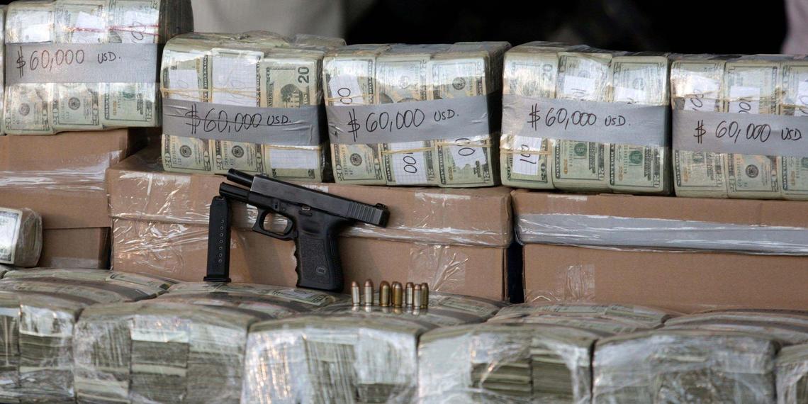 Mexican federal police present packets of U.S. dollars seized from four suspected members of the Norte del Valle de Colombia cartel during a news conference at the federal police center in Mexico City on March 9, 2010. Police said $2.7 million was taken.