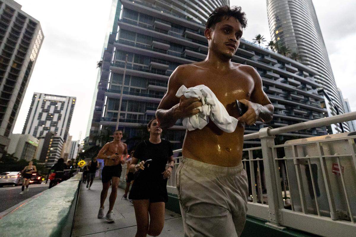 Members of the Brickell Run Club jog over the Brickell Avenue Bridge on Tuesday, September 3, 2025, in Miami, Fla.
