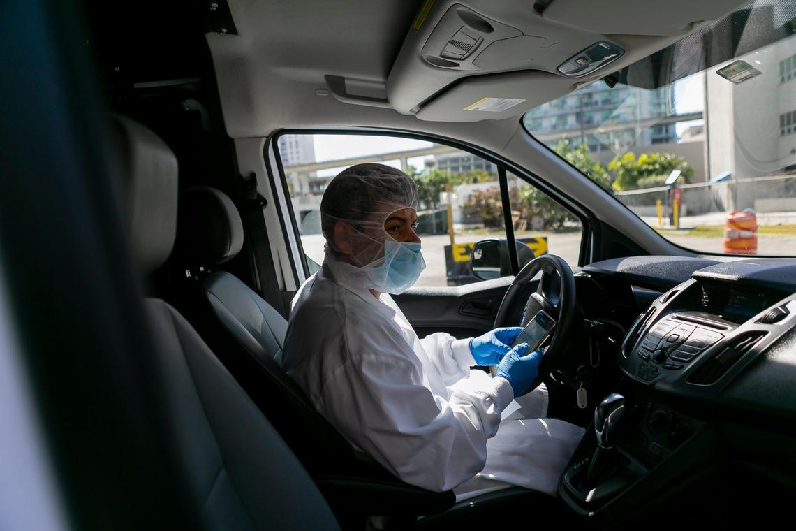 Yuri Kouzenkov, the director of operations for DeliverLean, delivers food to seniors in Brickell, Florida on Wednesday, March 25, 2020. DeliverLean has been hired by Miami-Dade County to help provide elderly residents with free meals during the COVID-19 pandemic.