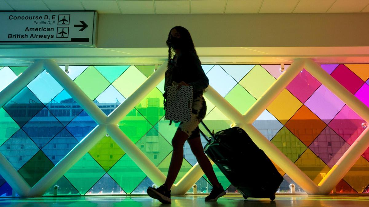 A traveler walks through Miami International Airport in Miami, Florida, on Monday, November 22, 2021.
