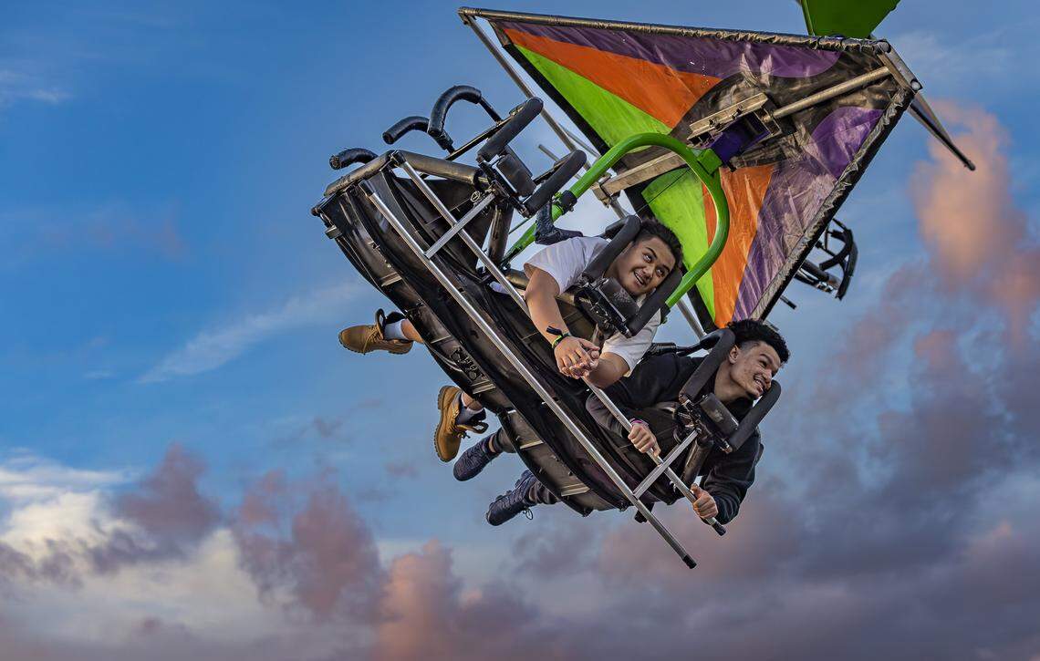 Samson Lee, left, and Anthony Acevedo, ride the Cliff Hanger attraction during the opening day of the 74th annual Miami-Dade County Youth Fair on Thursday, March 12, 2026, in Miami, Fla.