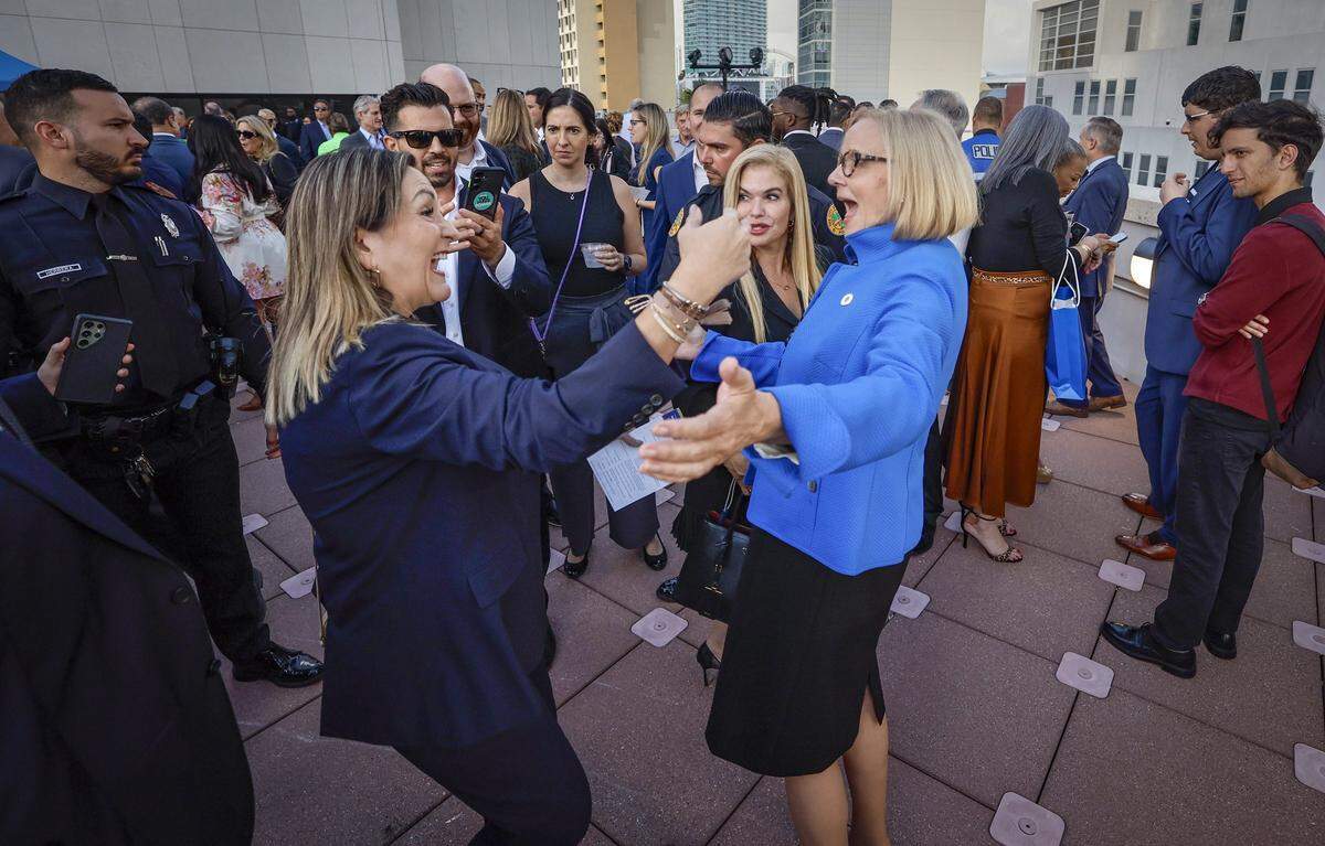 City of Miami Mayor Eileen Higgins, at right, is greeted by attendee Sandra Valencia during the reception that followed the conclusion of the installation ceremony for Eileen Higgins as the Mayor of the City of Miami at the Miami-Dade College Wolfson Campus Auditorium in Miami, Florida, on Thursday, December 18, 2025. 