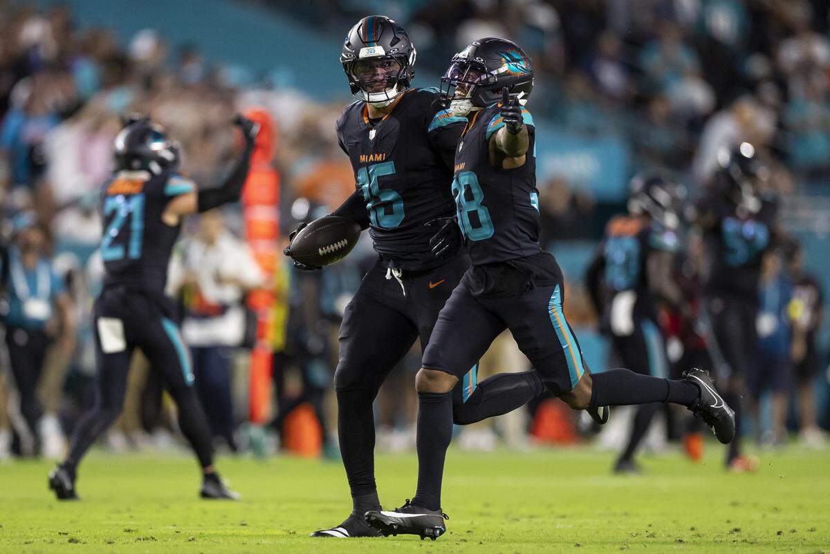 Miami Dolphins linebacker Jaelan Phillips (15) celebrates with defensive back Cornell Armstrong (38) after recovering a fumble against the New York Jets in the first half of their NFL game at Hard Rock Stadium on Monday, Sept. 29, 2025, in Miami Gardens, Fla.