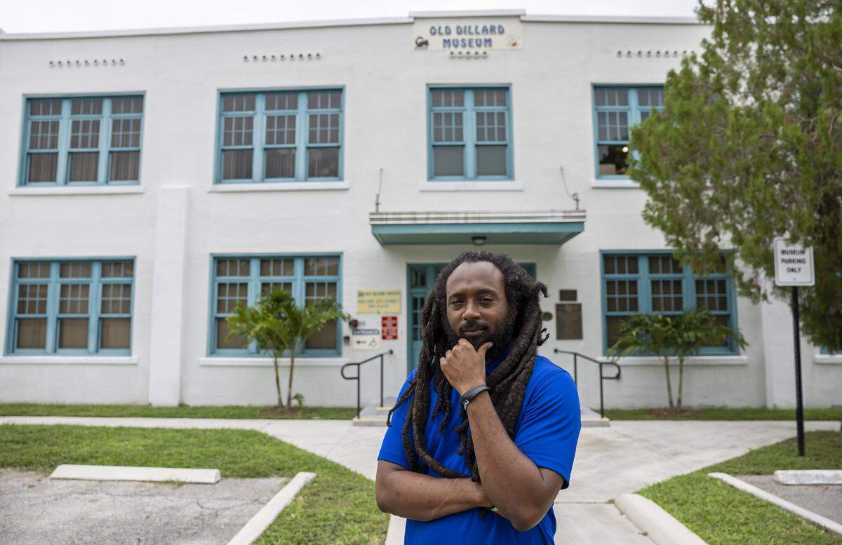 Emmanuel George, the curator of the Old Dillard Museum, is photographed outside the historic building in the Sistrunk neighborhood. George curated the latest exhibit “Sistrunk, Then & Now” to show how the Black neighborhood has changed over the decades.