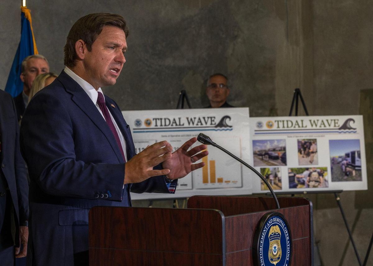 Florida Governor Ron DeSantis speaks by posters of people arrested in the Tidal Wave Operation during a press conference at the ICE-Enforcement and Removal Operation office in Miramar where he announced the results of the largest immigration operation in Florida history, a week-long joint effort with federal, state, and local law enforcement partners around the state, on Thursday May 01, 2025.