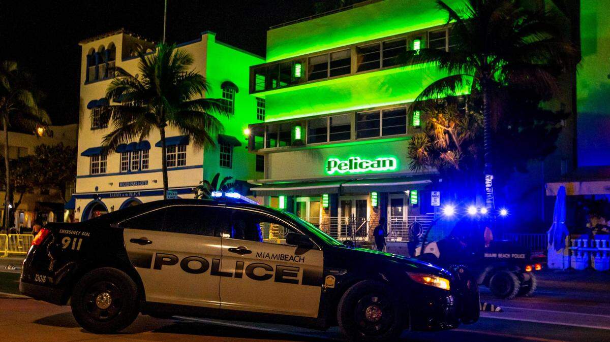 Miami Beach Police ride their all-terrain vehicles in the street as they clear Ocean Drive because the City of Miami Beach imposed a curfew at midnight to curb violence during spring break in Miami Beach, Florida, on Thursday, March 24, 2022.