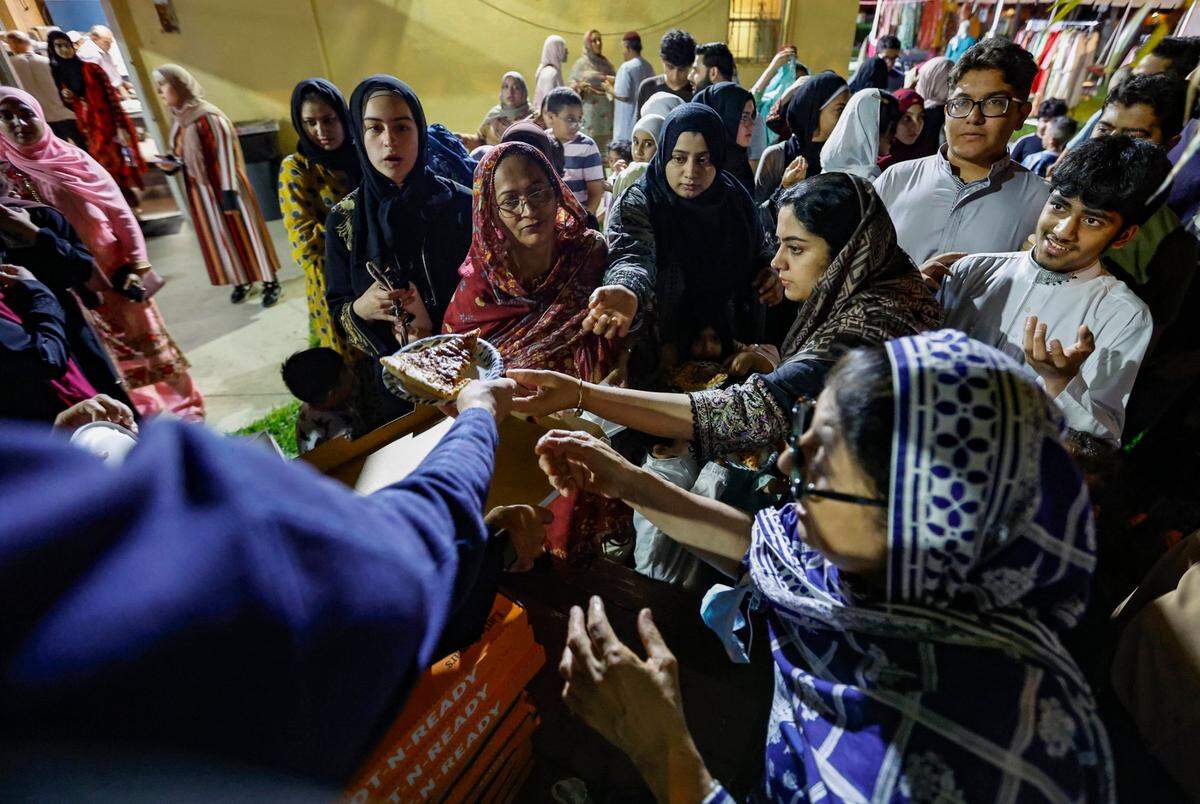 Congregants end their fast as they line up for food outside the Islamic Center of Greater Miami-Masjid in Miami Gardens, Florida, to celebrate the Day of Arafah.