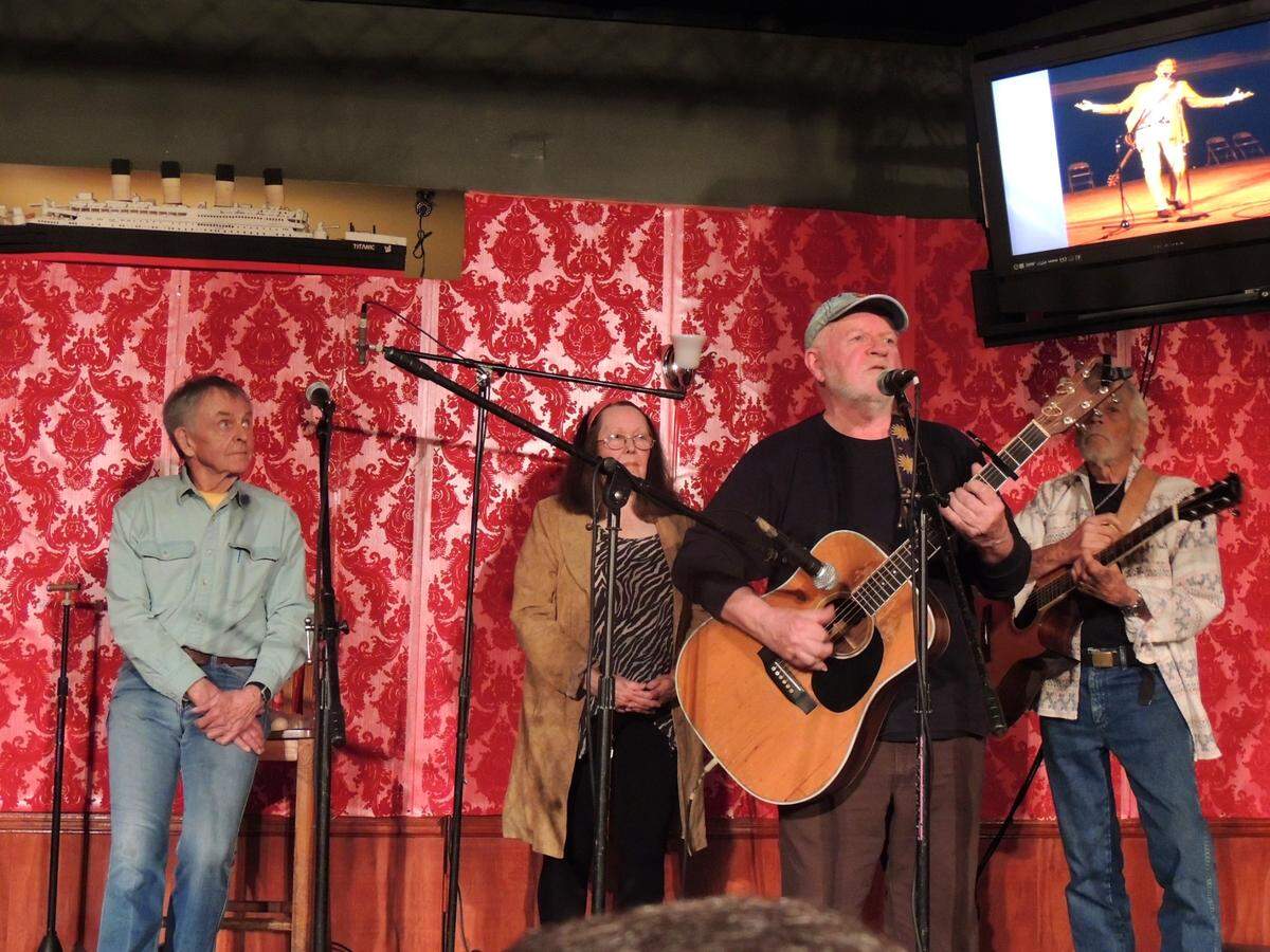 In this file photo from March 28, 2014, Michael Smith (center, with guitar) began the tribute portion of a Flick reunion concert at what is now Titanic Restaurant & Brewery at 5813 Ponce de Leon Blvd., in Coral Gables. The Flick was a 1960s, early-1970s coffeehouse where soon-to-be icons Joni Mitchell, David Crosby, Jimmy Buffett and Tim Buckley performed. Pictured (l-r): Chuck Mitchell, Barbara Barrow, Smith and Coconut Grove folk singer Bobby Ingram.