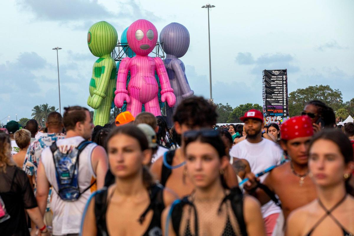 Festival goers walk the grounds during the first day of Rolling Loud Miami, an international hip-hop festival, at Hard Rock Stadium in Miami Gardens, Florida, on Friday, July 22, 2022.