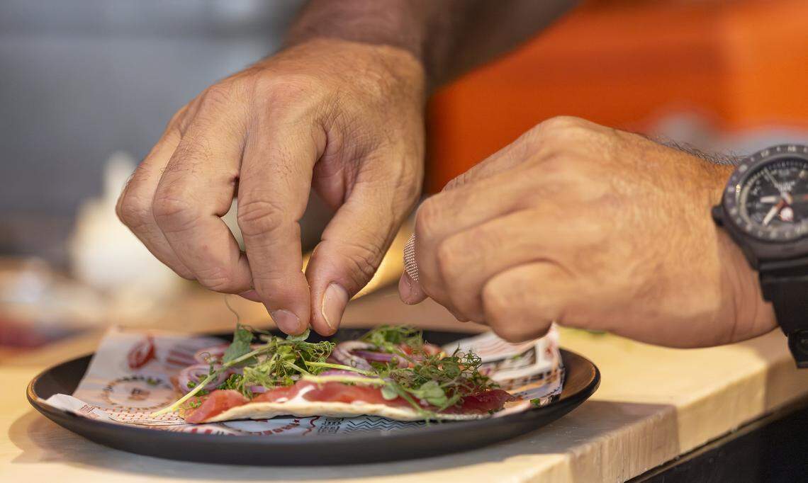 Chef Jose Mendin prepares a Tuna Pizza at his restaurant, Pubbelly Sushi, on Thursday, Sept. 18, 2025, in Miami Beach, Fla. Mendin, who is Puerto Rican, is celebrating the restaurant's 15th anniversary. The appetizer consists of crispy tortilla, garlic aioli and truffle oil.