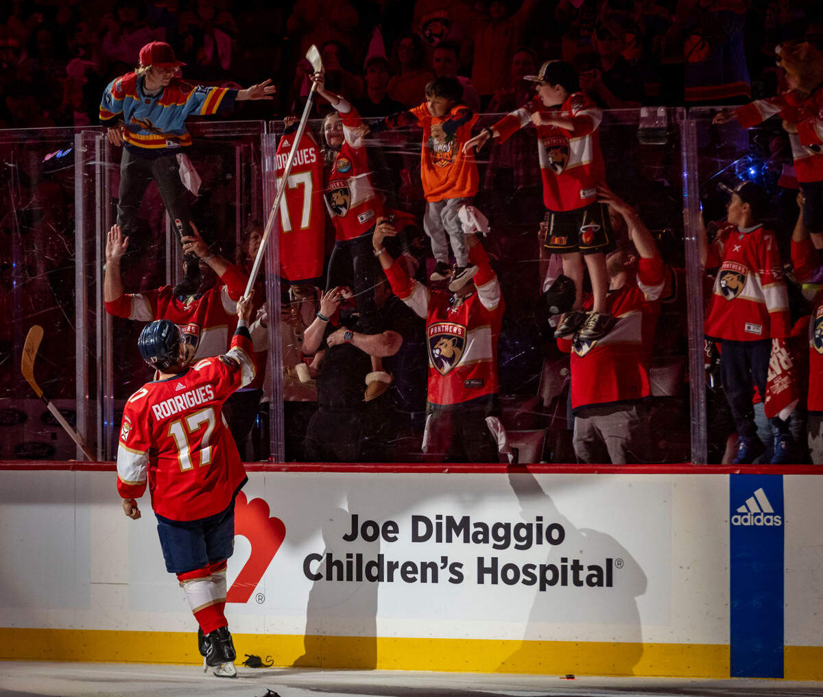 Sunrise, Florida, June 10, 2024 - Florida Panthers center Evan Rodrigues (17) who scored to goals in the game gives his stick to a fan after the game. The Florida Panthers defeated the Edmonton Oilers 4-1 in game 2 of the Stanley Cup Final to lead the series 2 -0. The series now moves to Edmonton .