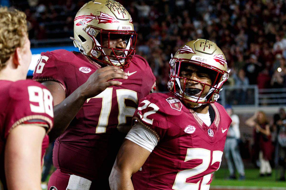 Nov 18, 2023; Tallahassee, Florida, USA; Florida State Seminoles running back CJ Campbell Jr. (22) and offensive lineman Darius Washington (76) celebrate a touchdown against the North Alabama Lions during the fourth quarter at Doak S. Campbell Stadium.