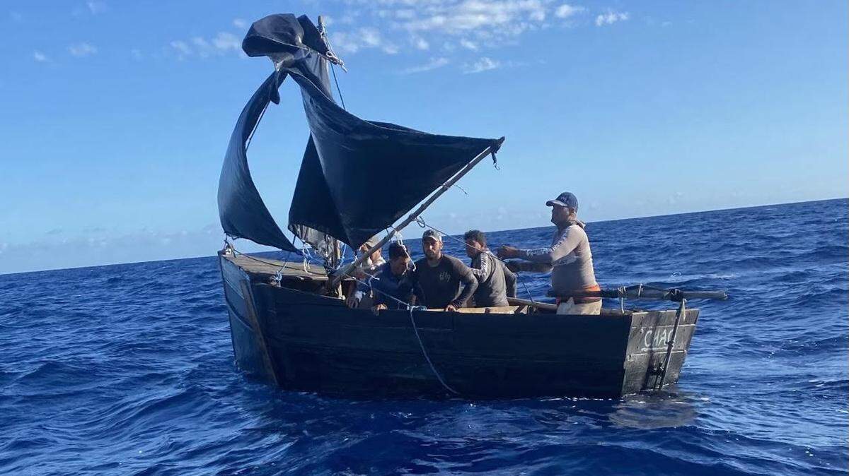 Five men sail in a migrant boat off the Lower Florida Keys Thursday, May 12, 2022. The men were taken into custody by the U.S. Coast Guard after being stopped by the agency and Monroe County Sheriff’s Office deputies.