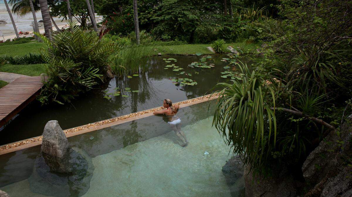 A woman looks out at the beach at the swimming pool at Kamalaya Wellness Sanctuary June 18, 2012.