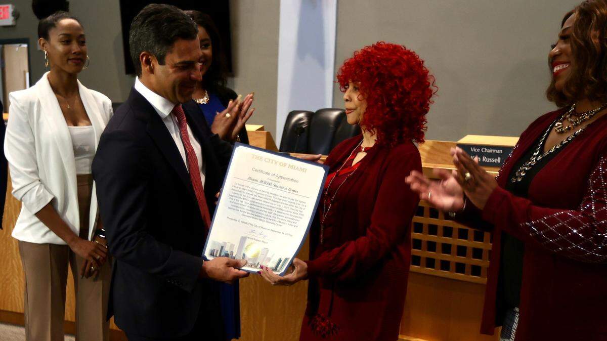 Miami Mayor Francis Suarez presents a certificate of appreciation to Marie Gill, whose consulting firm will operate the Miami Minority Business Development Agency Business Center.