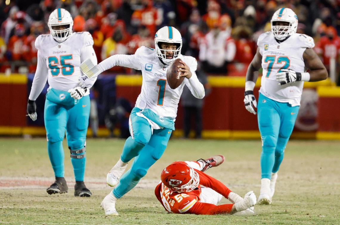 Miami Dolphins quarterback Tua Tagovailoa (1) scrambles in the second half against the Kansas City Chiefs at GEHA Field at Arrowhead Stadium in Kansas City, Missouri, on Saturday, January 13, 2024.