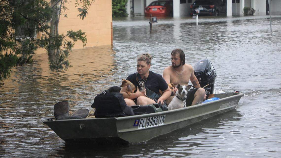 Residents and their pets evacuate Magnolia Avenue after Hurricane Milton flooded the neighborhood in South Daytona, Florida on Oct. 10, 2024.