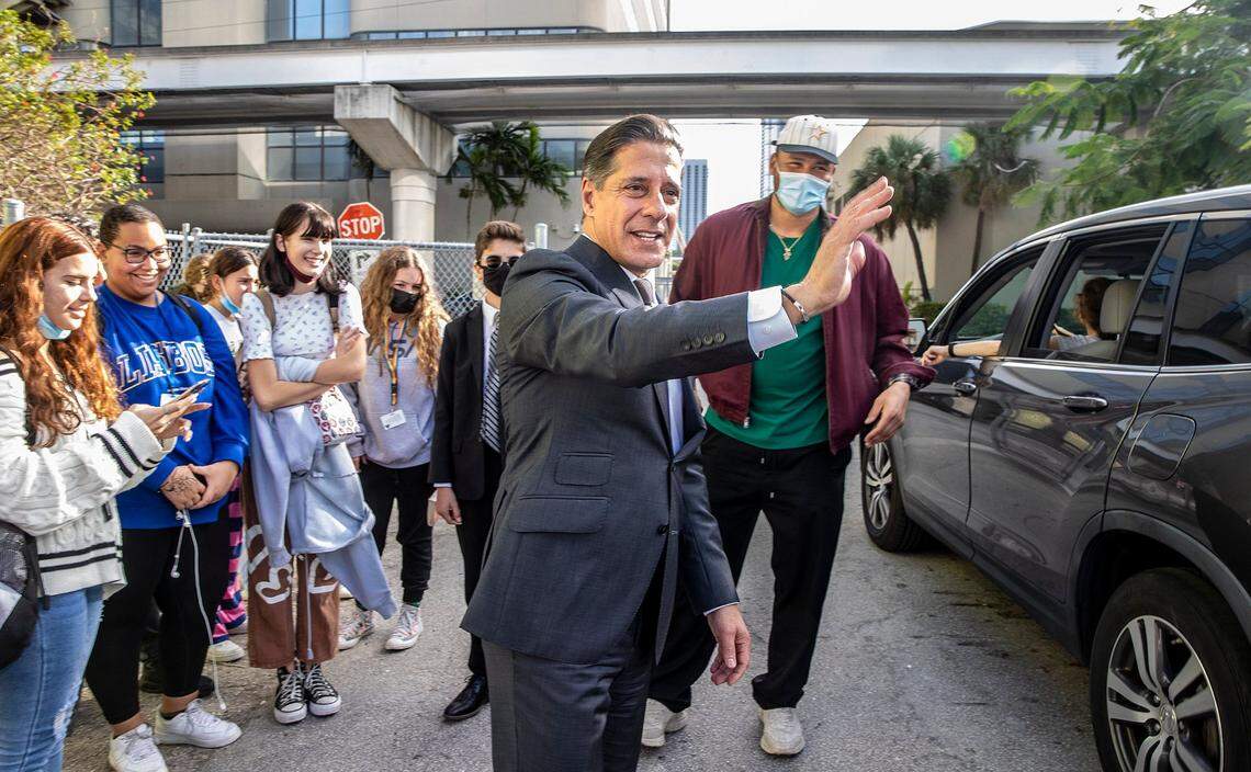 Miami Dolphins player Brennan Scarlett, far right, joins Miami-Dade Public Schools Superintendent Alberto Carvalho at iPrep Academy in Miami at dismissal time on Friday, Dec. 17, 2021.  Carvalho is set to leave his position in Miami and head to Los Angeles to lead its school system.