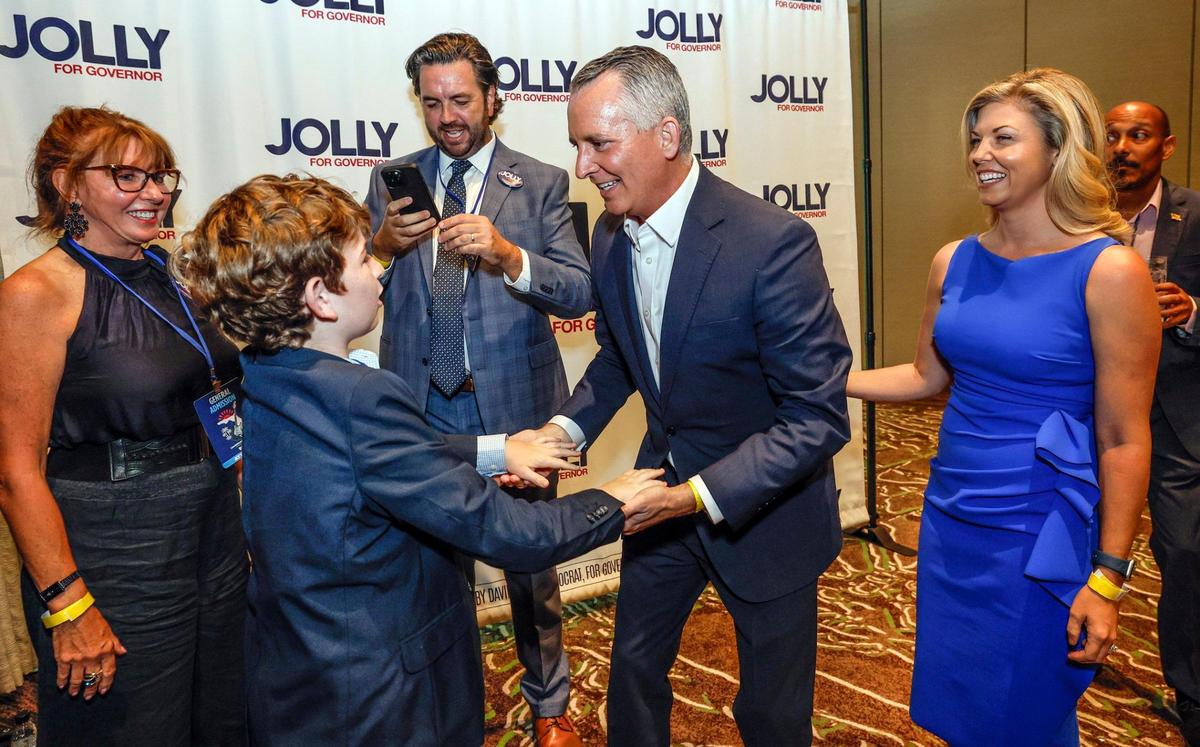 Candidate for Florida governor David Jolly meets with Mason Podvin, 10, during the Florida Democratic Party annual Leadership Blue Gala at the Hard Rock Hotel and Casino in Hollywood, Florida on Saturday, June 21, 2025.
