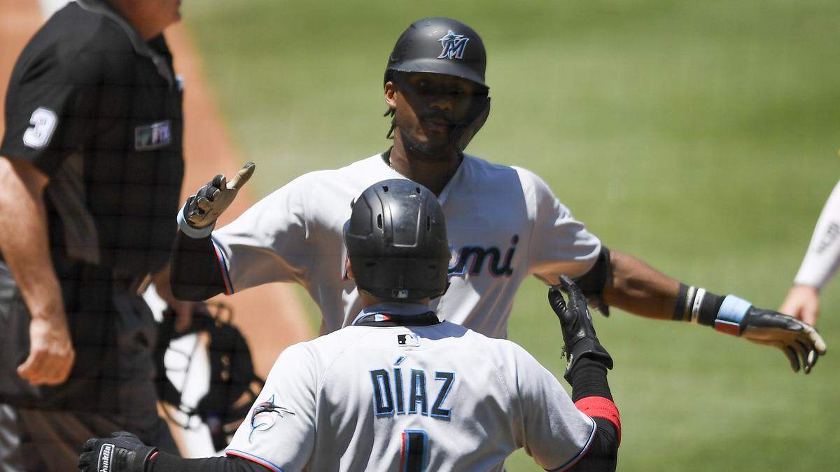 SAN DIEGO, CA - AUGUST 11: Lewis Brinson #25 of the Miami Marlins is congratulated by Isan Diaz #1 after hitting a two-run home run during the the first inning of a baseball game against the San Diego Padres at Petco Park on August 11, 2021 in San Diego, California. (Photo by Denis Poroy/Getty Images)