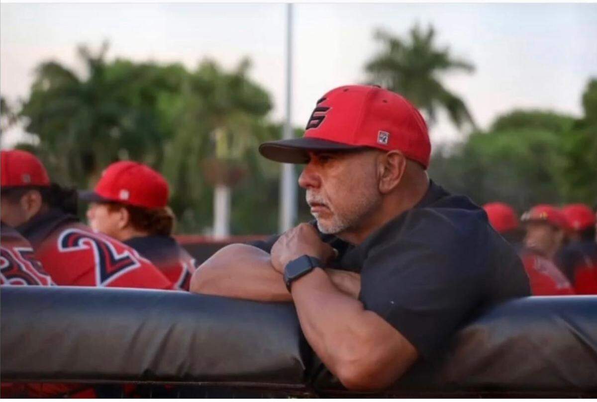 Ernie Padron watches from the dugout as he manages Coral Gables. The two-time state championship-winning coach retired this year after more than 30 years coaching across Miami-Dade County.