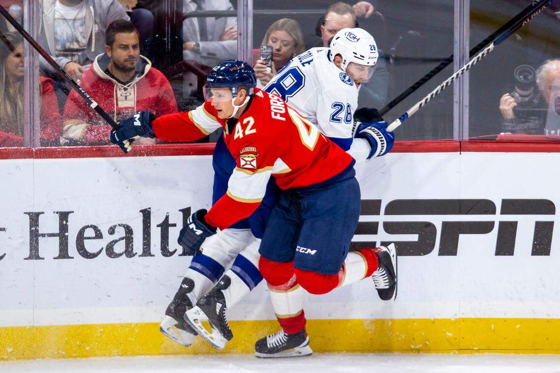 Florida Panthers defender Gustav Forsling (42) hits Tampa bay Lightning defender Ian Cole (28) during an NHL game at FLA Live Arena in Sunrise, Florida, on Friday, October 21, 2022.