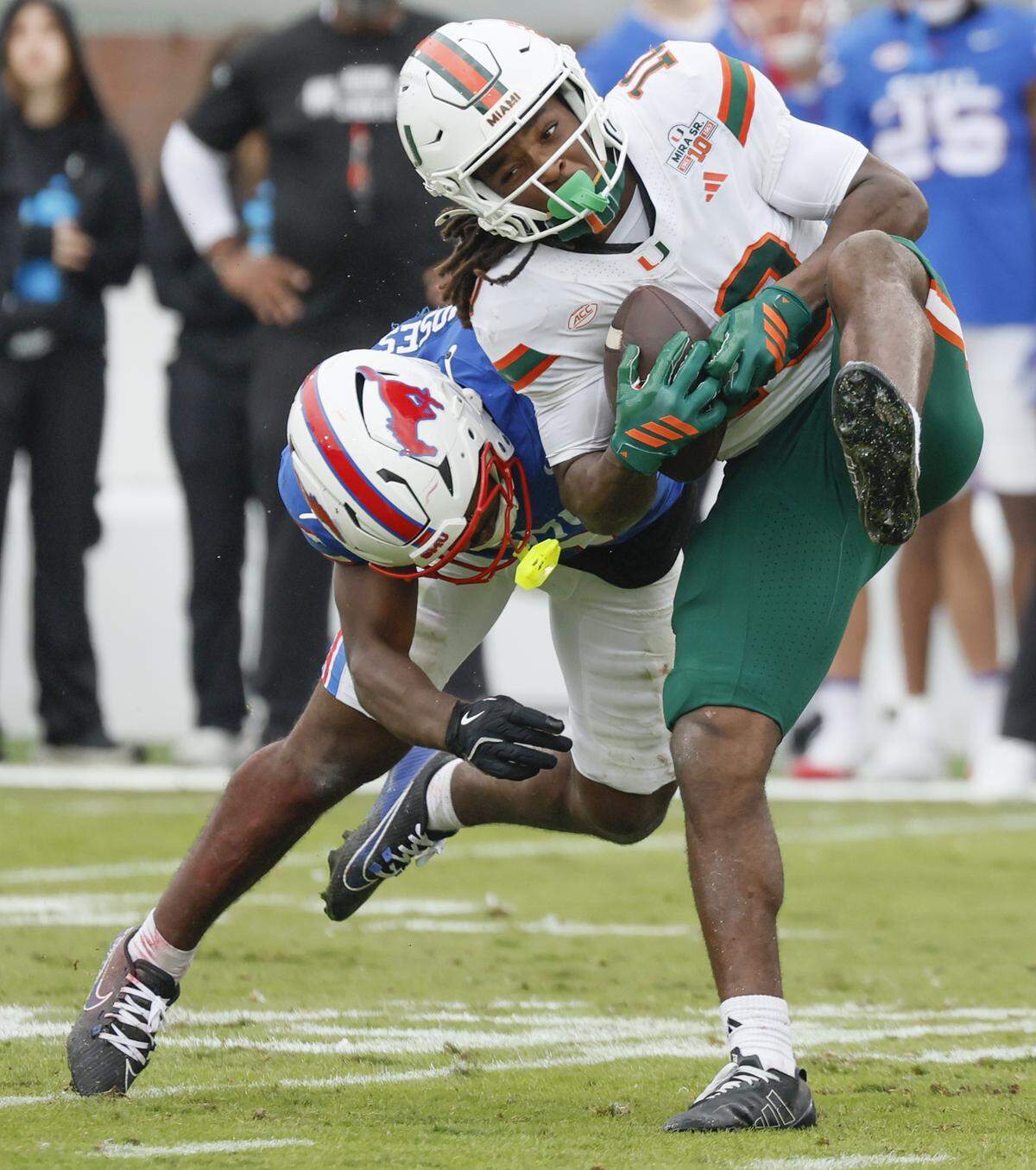 Miami Hurricanes wide receiver Malachi Toney (10) is hit on a pass reception by Southern Methodist University Mustangs safety Ahmaad Moses (3) during the first half of an NCAA football game at Gerald Ford Stadium on Saturday, November 1, 2025, in Dallas, Texas.
