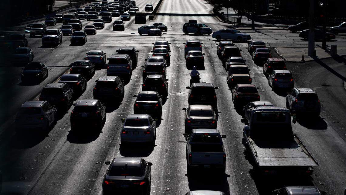 FILE - In this Thursday, April 22, 2021, file photo, cars wait at a red light during rush hour at the Las Vegas Strip, in Las Vegas. Used car prices have increased during the pandemic. (AP Photo/John Locher, File)