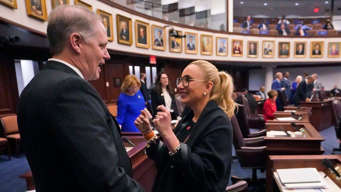 Florida Senate President Wilton Simpson, left, chats with Sen. Lauren Book, D-Plantation, before the start of a legislative session, Thursday, April 29, 2021, at the Capitol in Tallahassee, Fla.