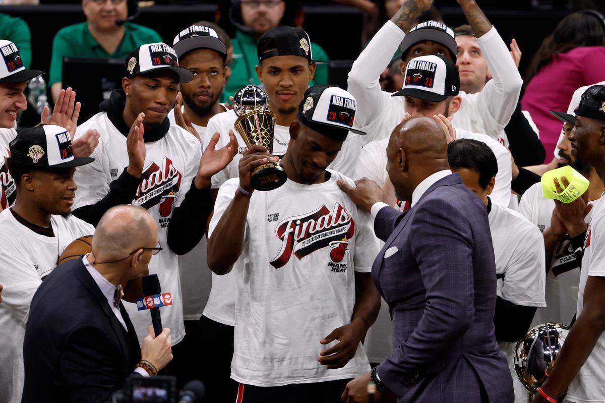 Miami Heat forward Jimmy Butler (22) celebrates with the MVP trophy after the Heat defeated the Boston Celtics in game seven of the Eastern Conference Finals for the 2023 NBA playoffs at TD Garden.