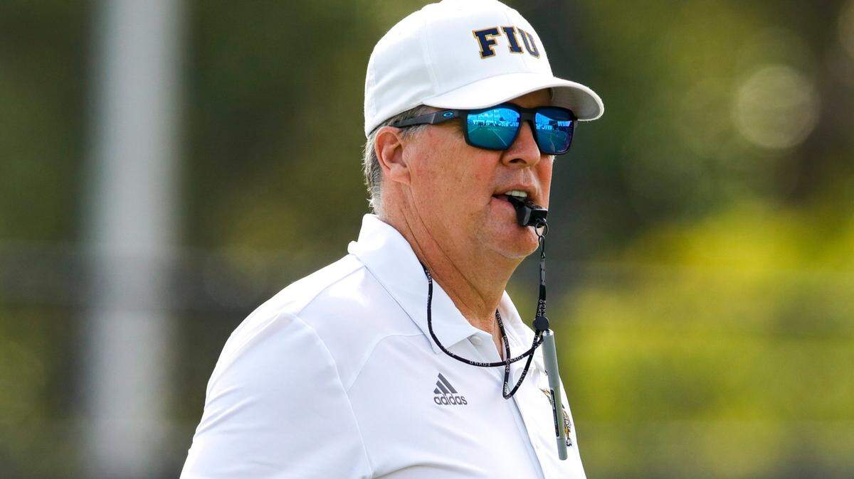 Florida International University head coach Mike MacIntyre watches from the field during football practice at the practice fields at Florida International University in Miami, Florida, on Thursday, March 24, 2022.