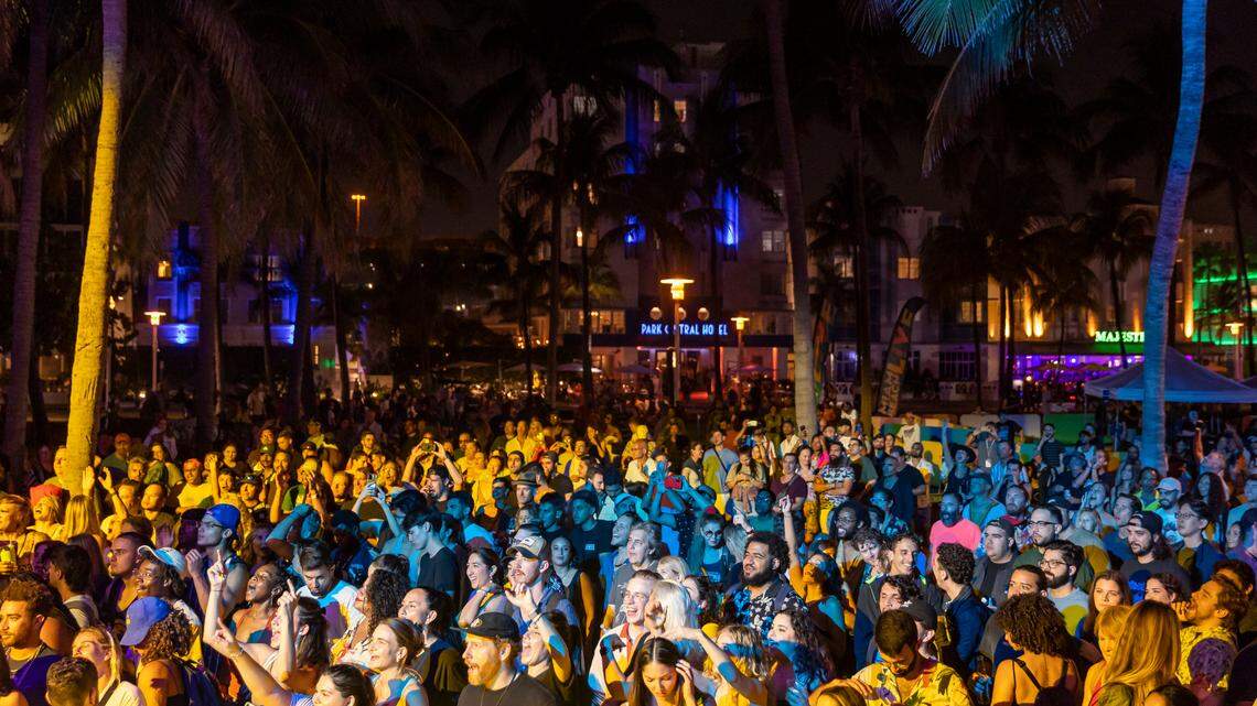 People watch a concert at Lummus Park during spring break on Saturday, March 11, 2023, in Miami Beach, Fla.