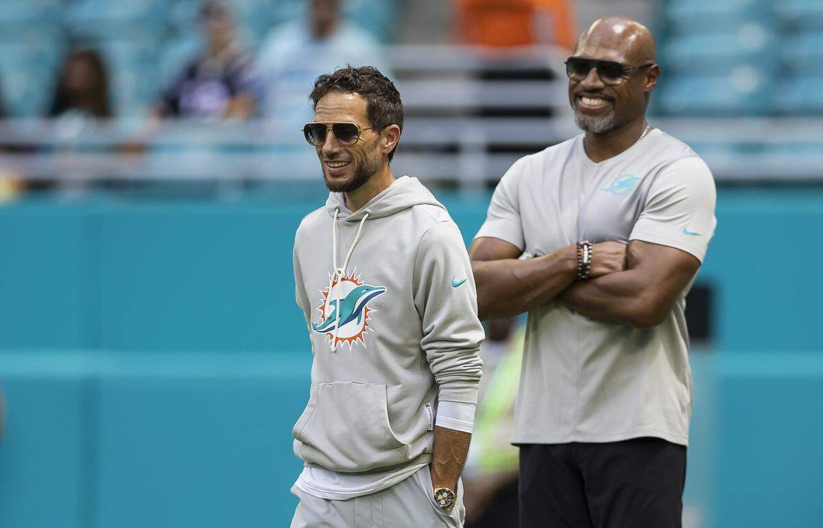 Miami Dolphins head coach Mike McDaniel and defensive coordinator Anthony Weaver watch their team warm up before playing against the New England Patriots in their NFL game at Hard Rock Stadium on Sunday, Sept. 14, 2025, in Miami Gardens, Fla.