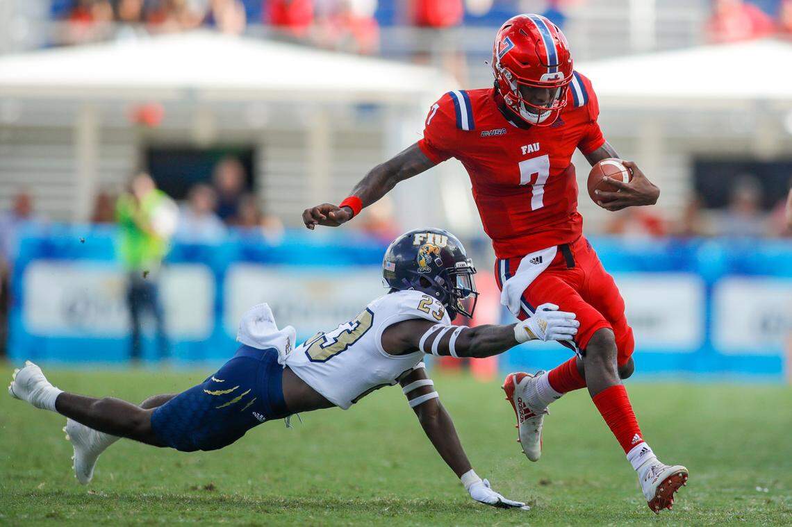 Florida Atlantic Owls quarterback N’Kosi Perry (7) runs with the football as Florida International University defensive back Andrew Volmar (23) attends a tackle during the second quarter of the Shula Bowl game at FAU Stadium in Boca Raton, Florida on Saturday, October 2, 2021.