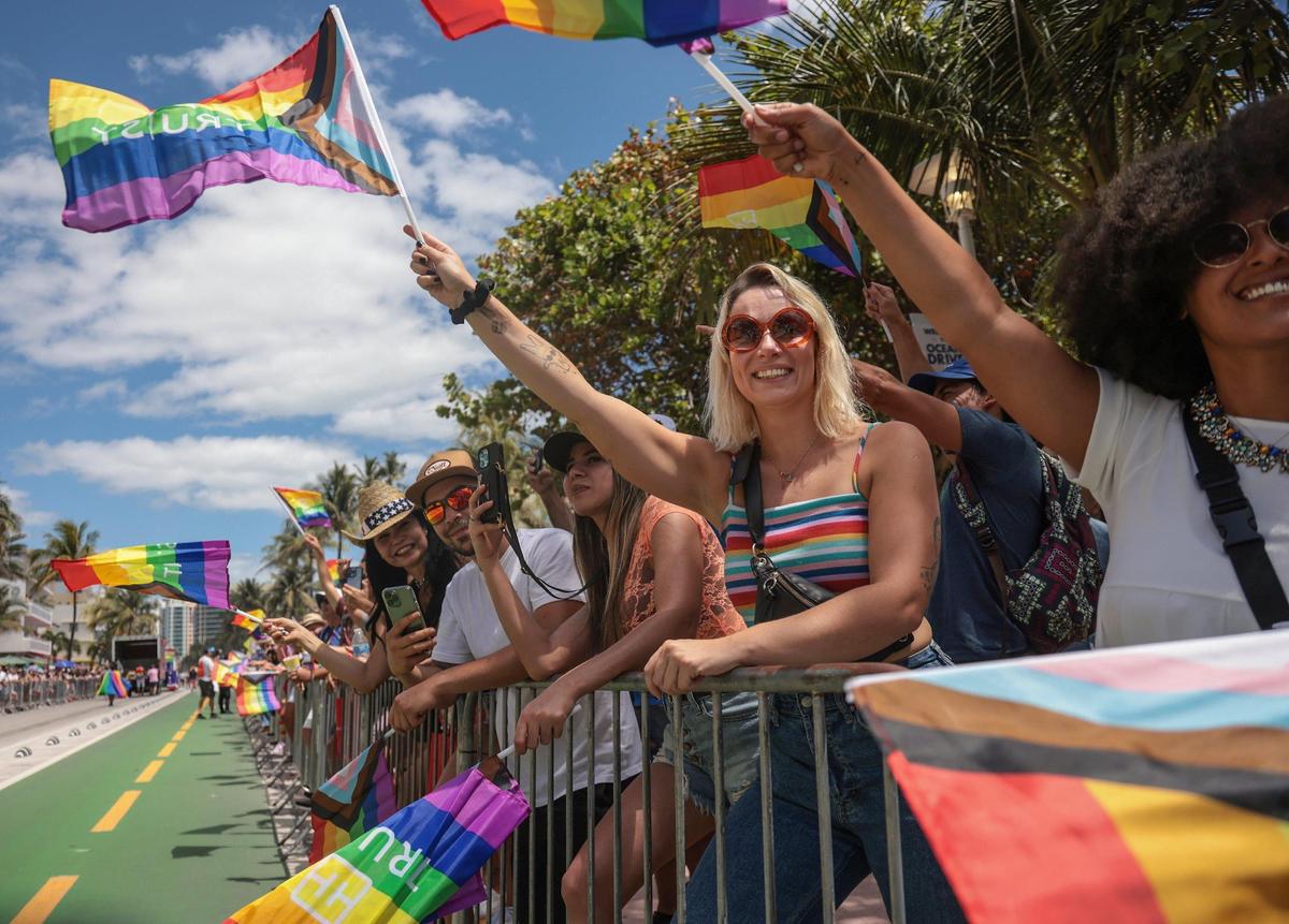 Attendees of the Miami Beach Pride Parade on April 10 wave their rainbow flags in celebration of LGBTQ pride.