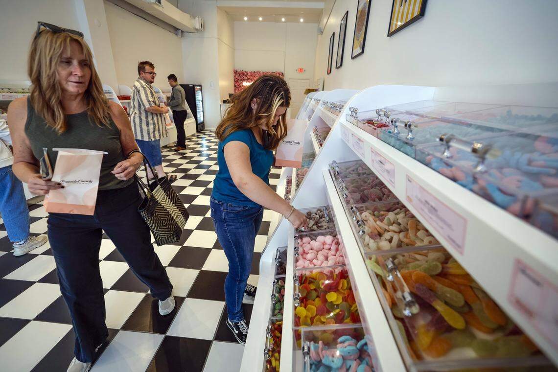 Bryn Ingram joins fellow customers on decided what to choose from a large asortment of candy offered at the Scandy Candy store on Miracle Mile in Coral Gables, Florida, on Thursday, September 4, 2025.