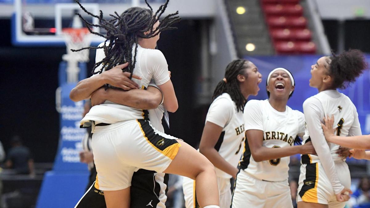 American Heritage’s Jasleen Green (34) jumps into the arms of one the coaches after the Class 5A final against Mainland as other players celebrate during the Florida High School State Championships at the RP Funding Center in Lakeland, Fl on Friday March 8, 2024. American Heritage defeated Mainland 60-55 to win the Class 5A State Title. Scott Wheeler | Photo
