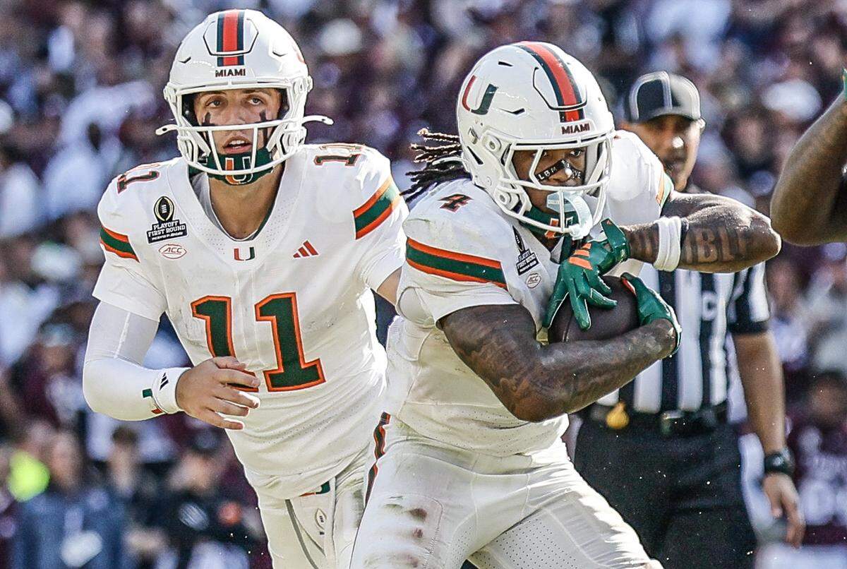 Miami Hurricanes quarterback Carson Beck (11) hands off to Miami Hurricanes running back Mark Fletcher Jr. (4) in the second half of the first round of the 2025 College Football Playoff against the Texas A&M Aggies at Kyle Field at College Station, Texas, on Saturday, December 20, 2025.