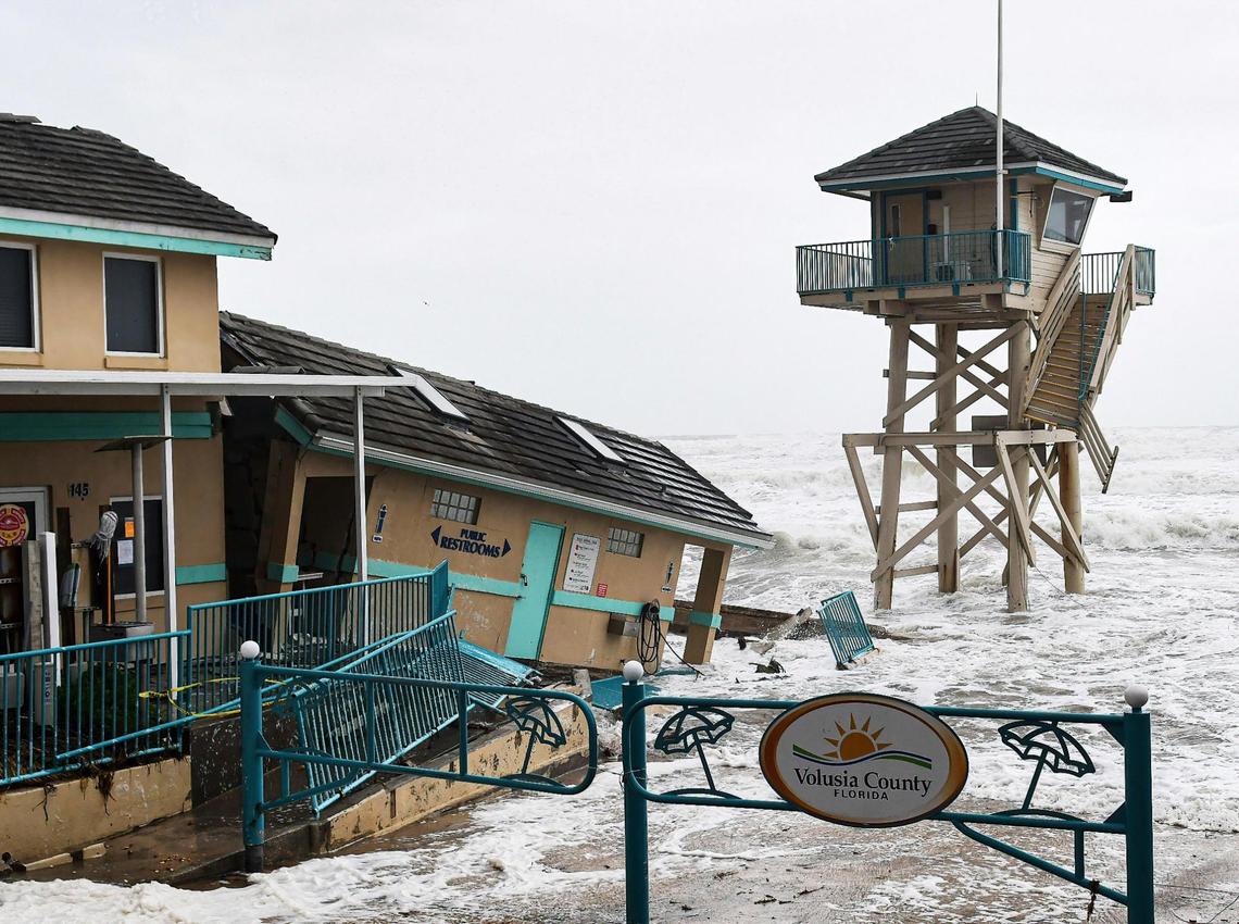 Waves crashed near a damaged building and a lifeguard tower in Daytona Beach Shores, Florida as Hurricane Nicole approached the coast of Florida.