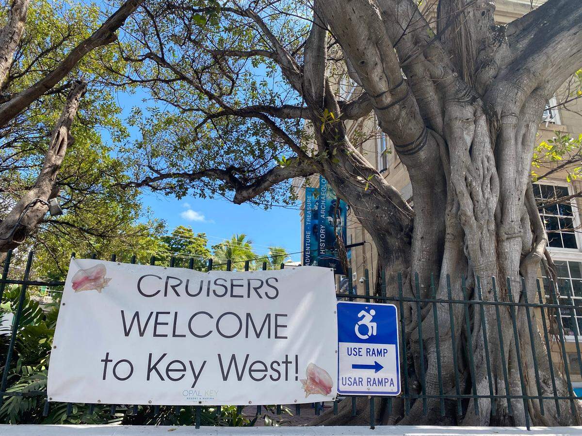 A banner outside the Mel Fisher Maritime Museum in downtown Key West welcomes cruise ship passengers to the island at a time when locals are divided over the industry’s impact on the island.