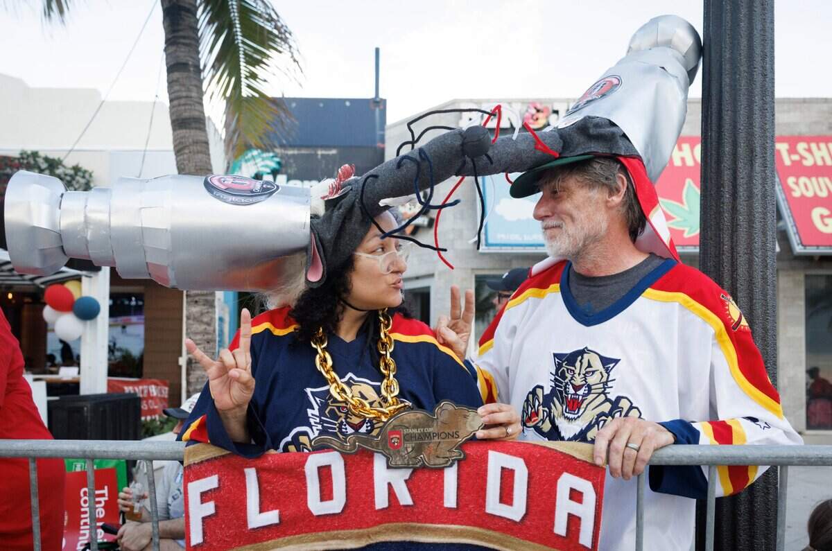 Roxanne Schneider, left, and John, pose in their rat outfits before the Florida Panthers Stanley Cup Championship victory parade.