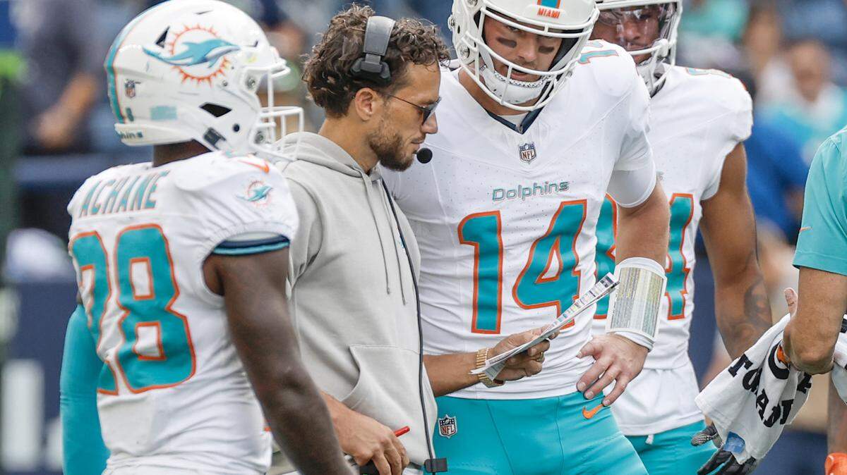 Miami Dolphins head coach Mike McDaniel speaks with quarterback Tim Boyle (14) during a timeout in the second half against the Seattle Seahawks in an NFL game at Lumen Field in Seattle, Washington on Sunday, September 22, 2024.