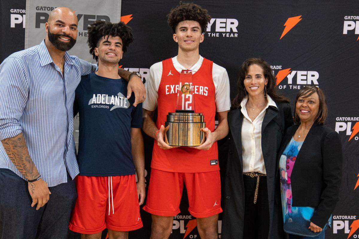 Columbus basketball star Cameron Boozer (middle), flanked by his father, Carlos (far left), brother Cayden (left), mother, Cindy (right) and his grandmother, Jacquenetta Miles (far right), poses with the Gatorade National Boys Basketball Player of the Year Award trophy, which he was presented during a ceremony this week at Columbus High School.
