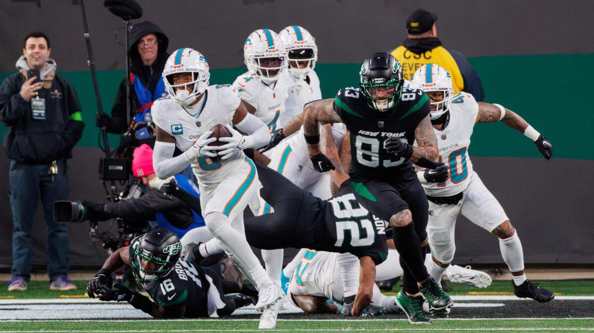 Miami Dolphins safety Jevon Holland (8) runs after intercepting a pass during second quarter of an NFL football game against the New York Jets at MetLife Stadium on Friday, Nov. 24, 2023 in East Rutherford, New Jersey.