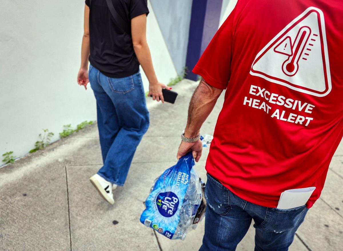 Homeless Trust Chairman Ron Book, right, walks with its outreach team as they surveyed the downtown and offered services to unhoused individuals on the street on Thursday, Aug. 1, 2024, in Miami, Florida.