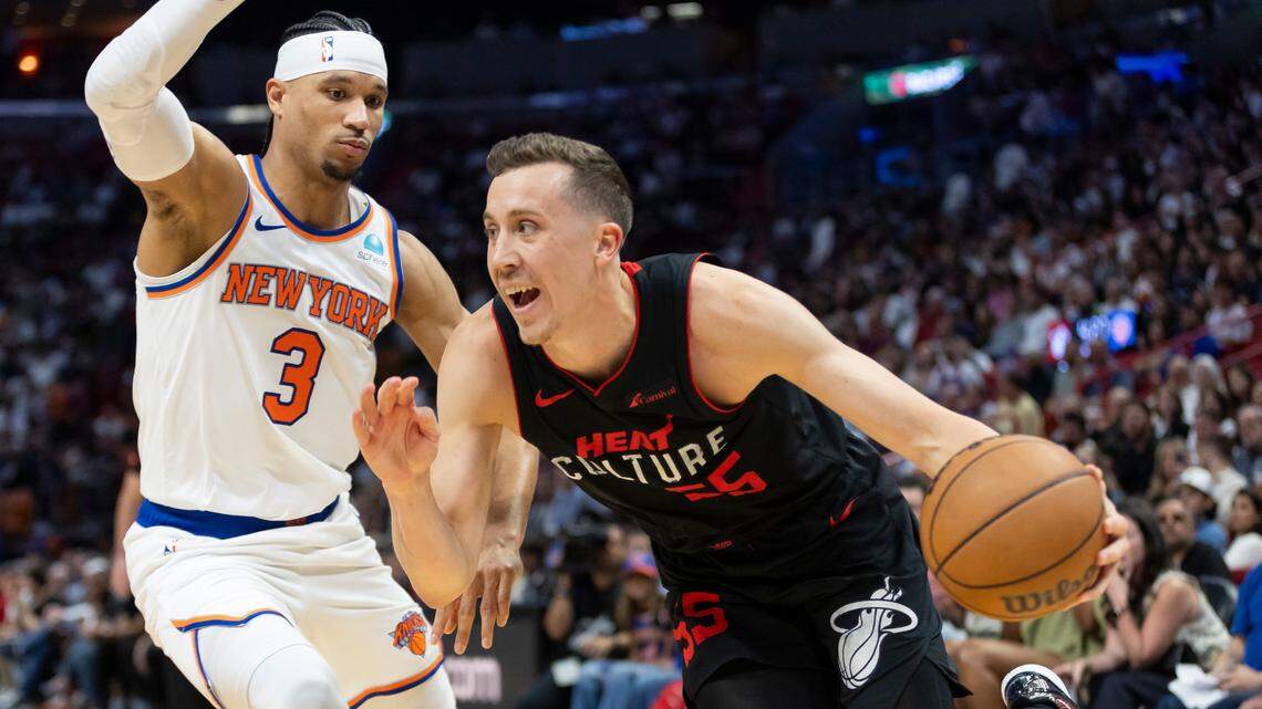 Miami Heat forward Duncan Robinson (55) drives the ball as New York Knicks guard Josh Hart (3) defends in the second half of their NBA game at Kaseya Center on Tuesday, April 2, 2024, in Miami.