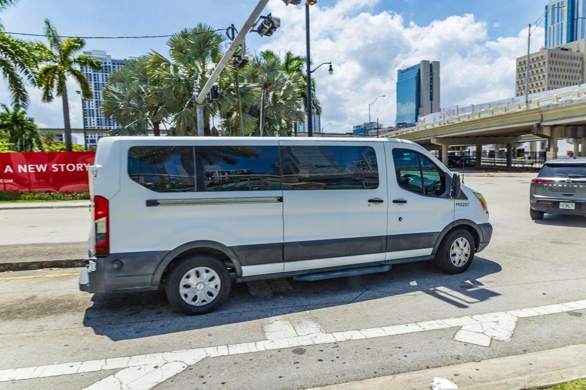 A U.S. Immigration and Customs Enforcement van drives away after taking a group of men who were detained at the Executive Office for Immigration Review building in Miami on Wednesday, May 21, 2025.