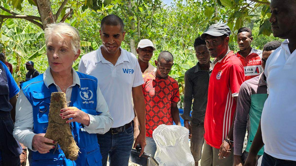 in this file photo, Cindy McCain, the executive director of the U.N. World Food Program, holds up a yam while touring a farmers’ co-op in the Grand’Anse region of Haiti on Monday, June 19, 2023.